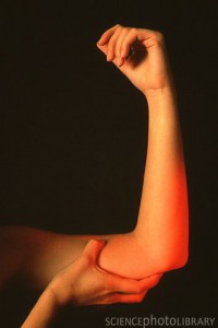 Woman_holding_her_painful_elbow